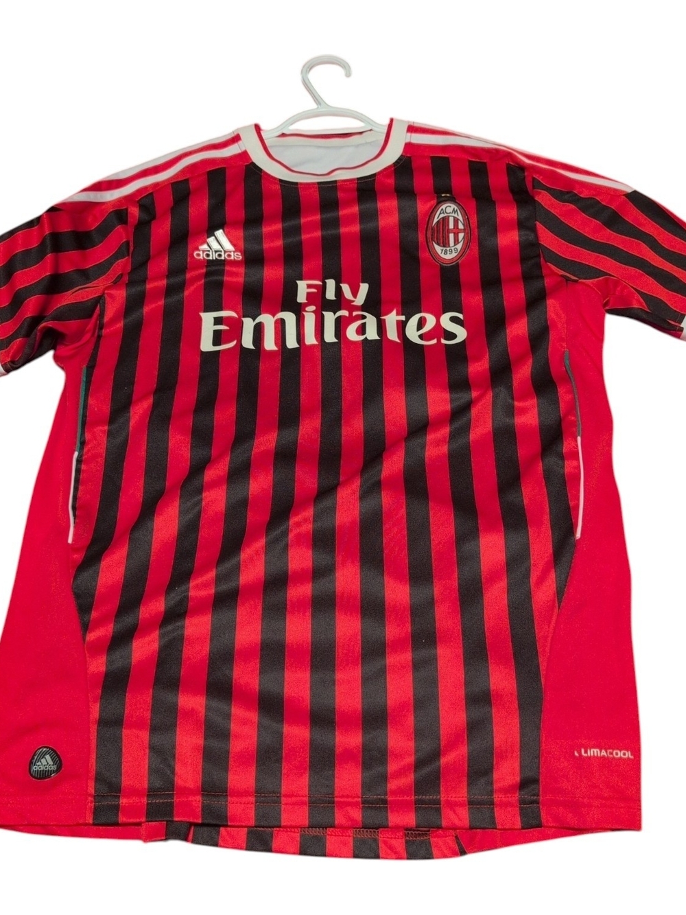 Soccer jersey with vertical red and black stripes